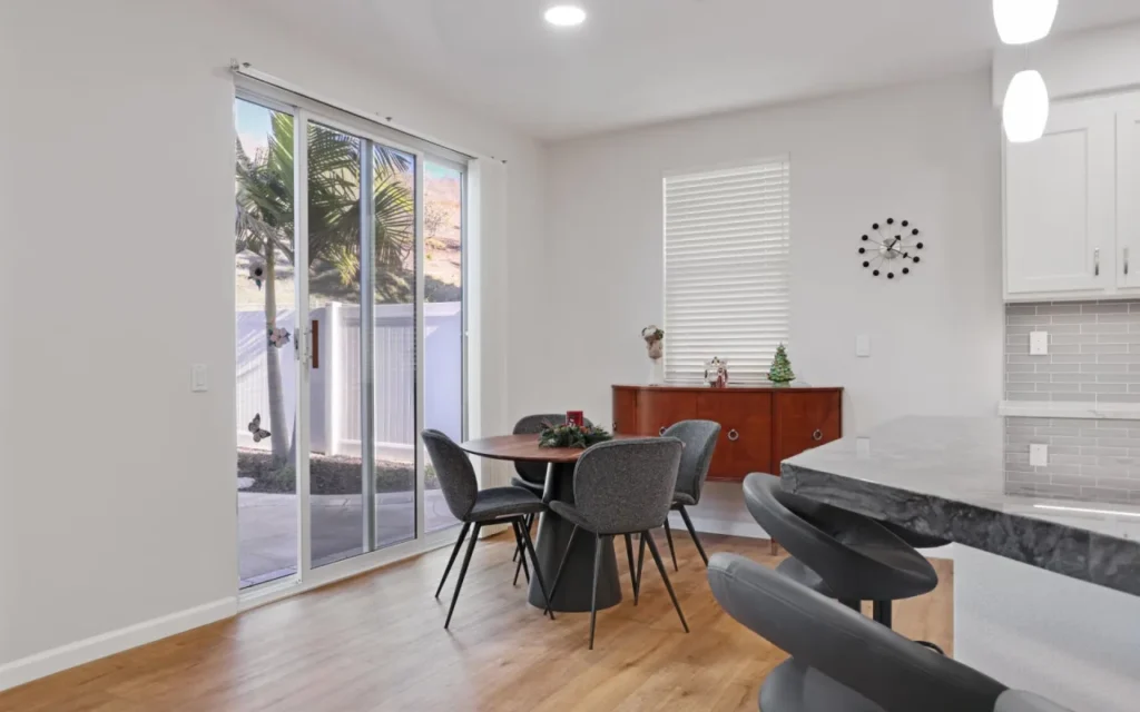 Dining area with a round table and four chairs.