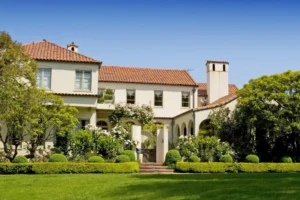 Large house with a red tile roof and white walls.