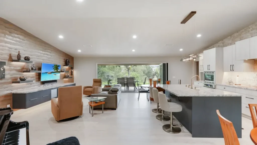 An open living space with a kitchen, living room, and dining room.