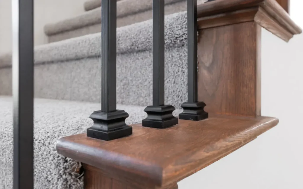 Black metal balusters on wooden staircase.