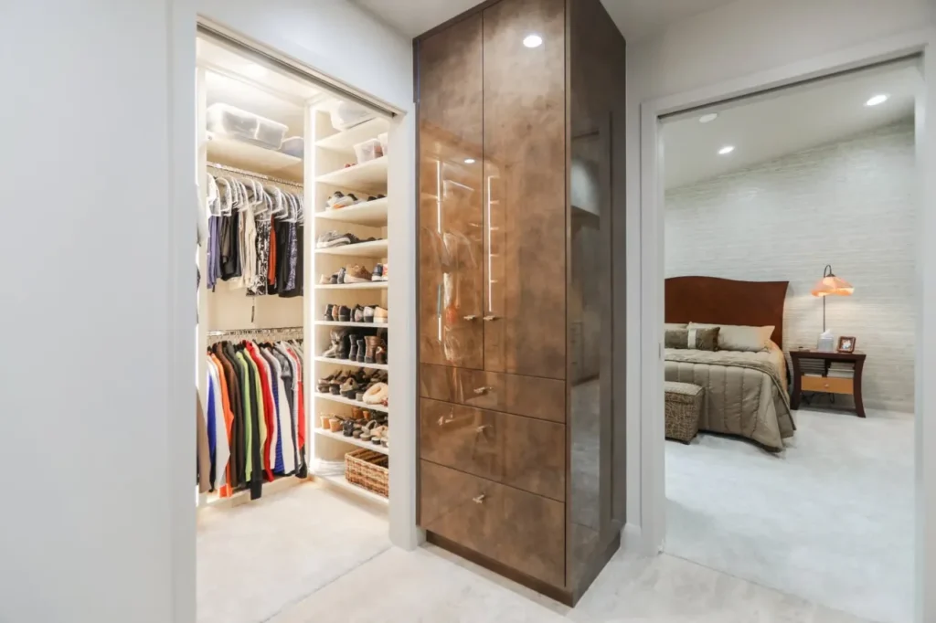 Walk-in closet with clothes and shoes.