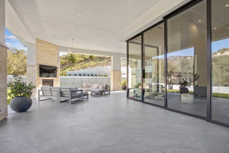 Modern patio with outdoor seating and fireplace.