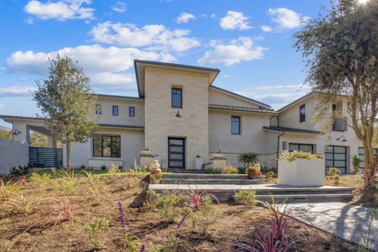 A modern house with a stone and stucco exterior.