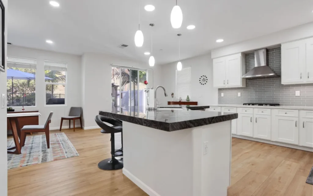 A modern kitchen with a large island and stainless steel appliances.
