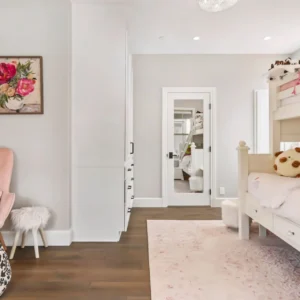 Bedroom with pink accents and bunk beds.