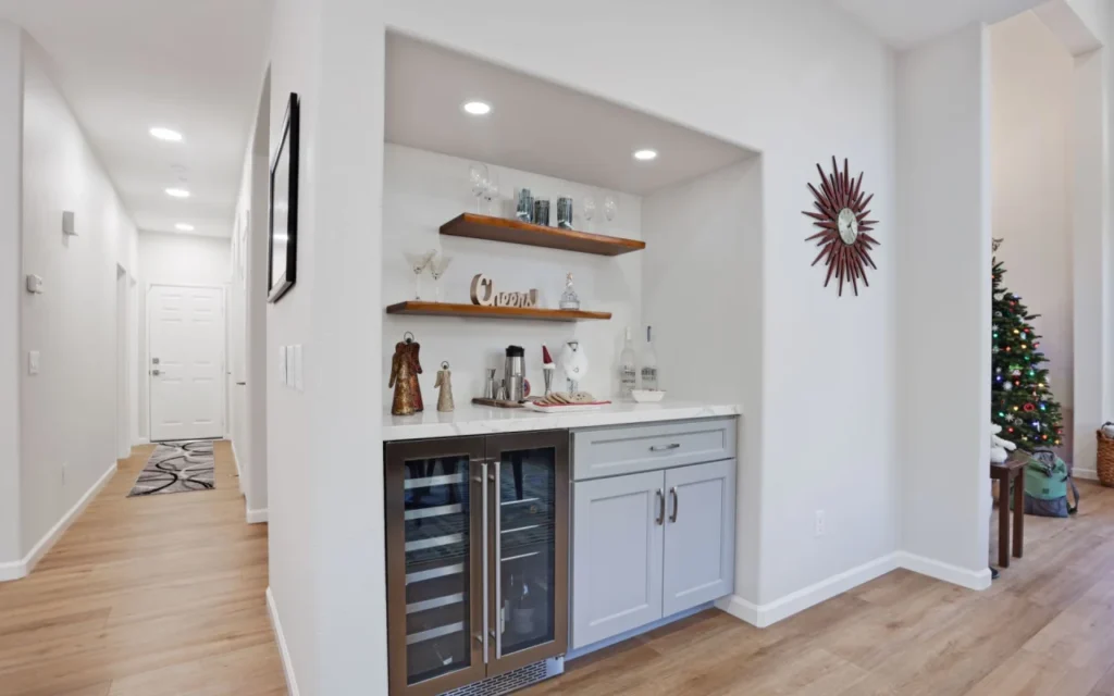 Butler's pantry with wine rack and mini fridge.