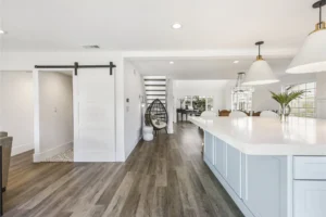 Large kitchen with island and view of living room.