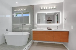 Modern bathroom with large bathtub and double vanity.