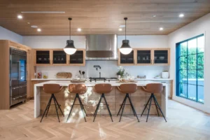 Modern kitchen with wood ceiling and marble island.