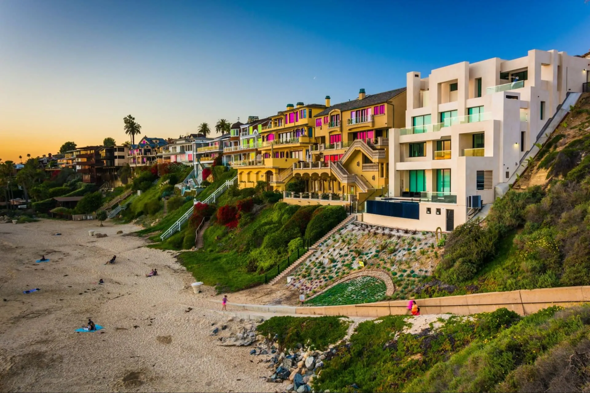 Colorful beach houses on a hill overlooking the ocean.