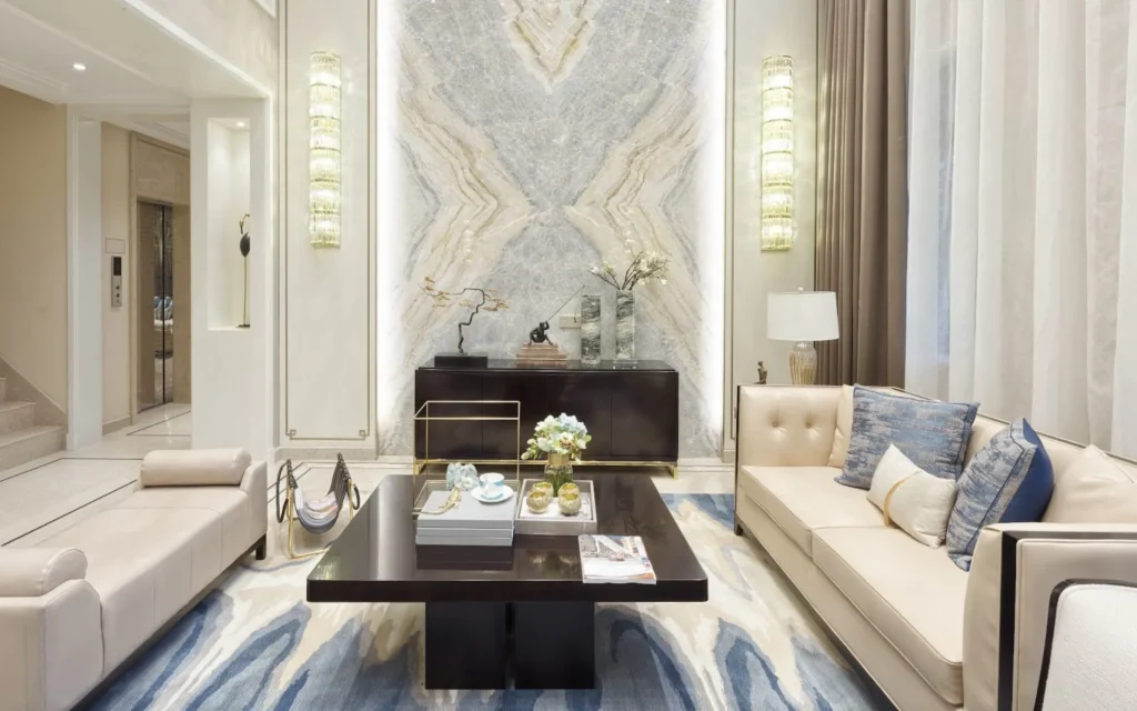 Bright living room with marble wall and blue accents.