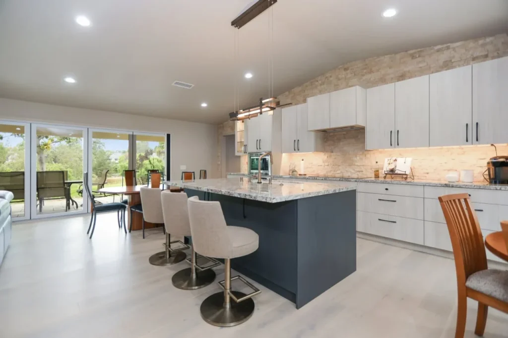 Modern kitchen with island and stone accent wall.