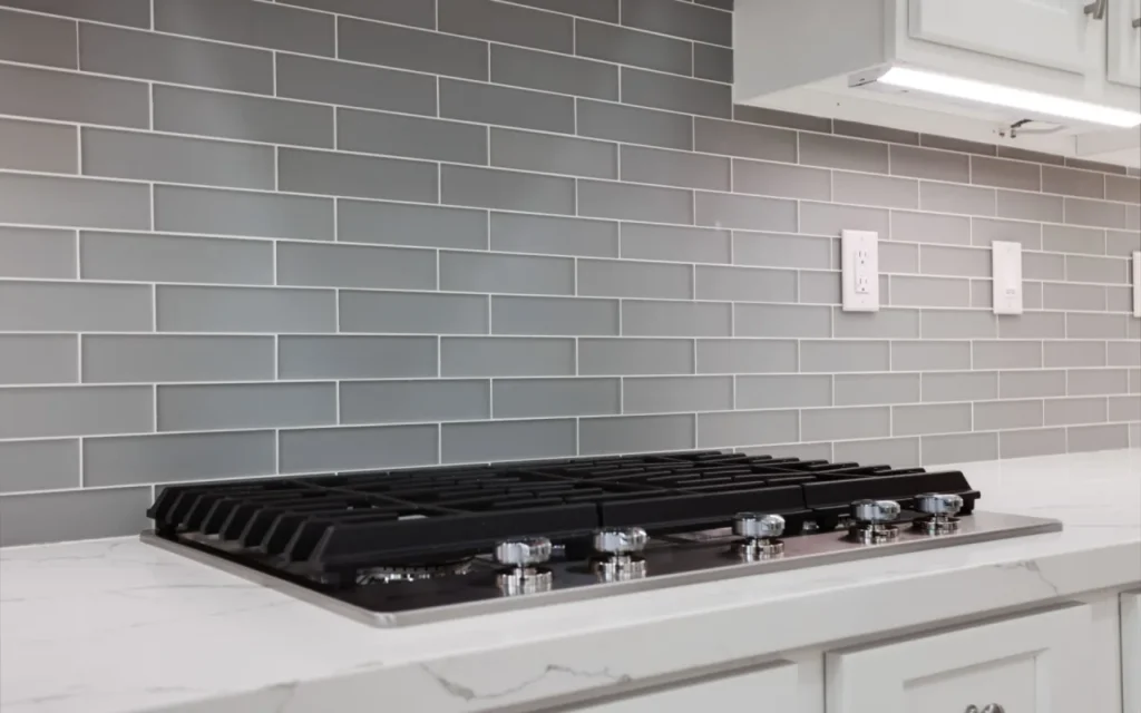 Gray glass subway tiles in kitchen.