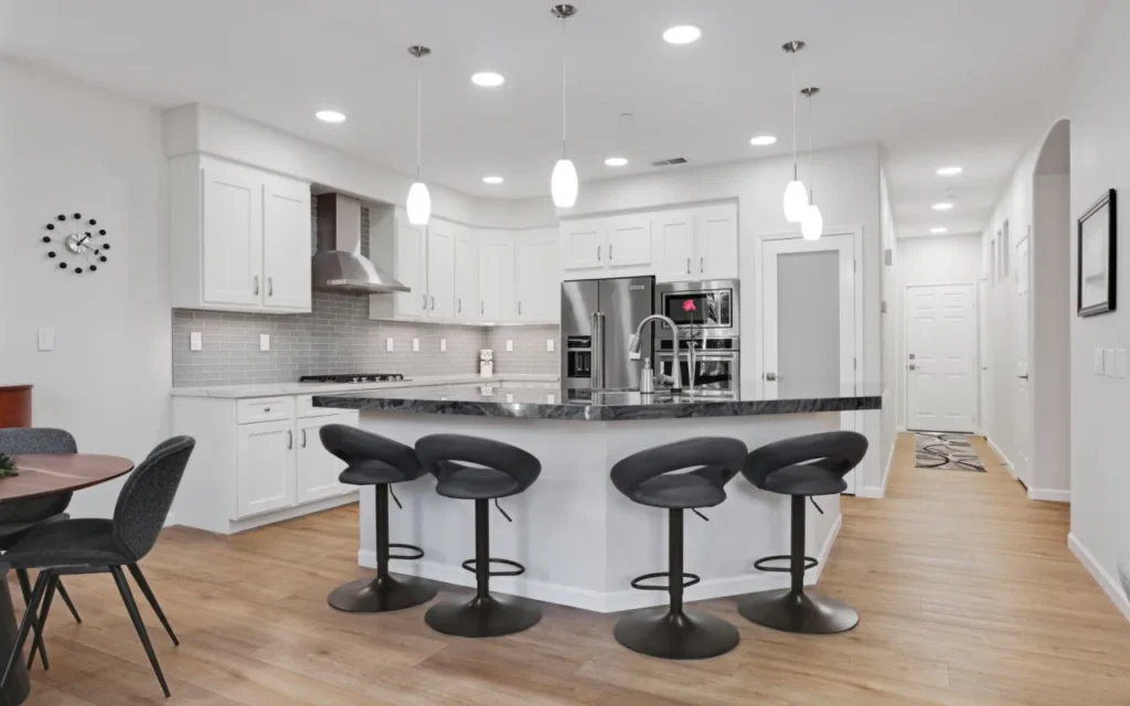 Modern kitchen with white cabinets and stainless steel appliances