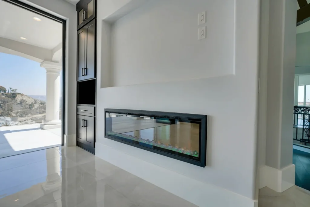 A modern fireplace with a white mantel.