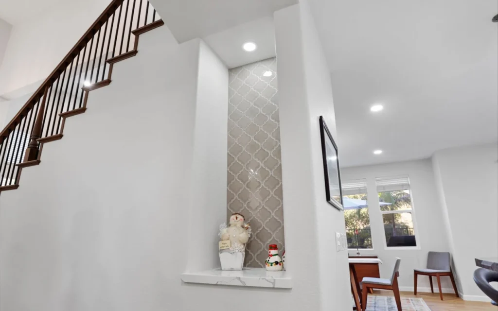 Staircase and living room with niche.