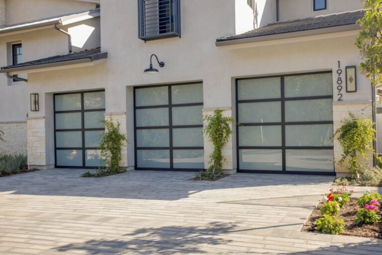 Three frosted glass garage doors with black frames.