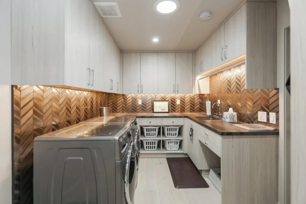 Laundry room with bronze accents and white cabinets