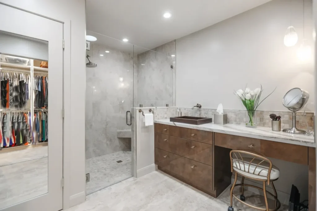 Modern bathroom with glass shower and marble vanity.