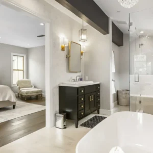 Black vanity, vessel sink, bathtub, and glass shower.