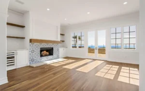 Bright living room with fireplace and ocean view.