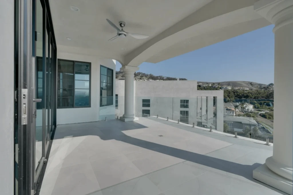 Balcony with a view of the city and hills.