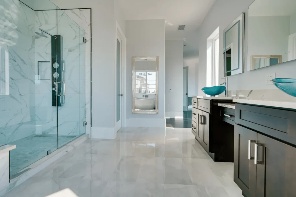 Modern bathroom with large glass shower and soaking tub.