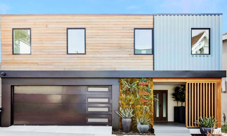 A modern house with wood and metal siding and a garage.