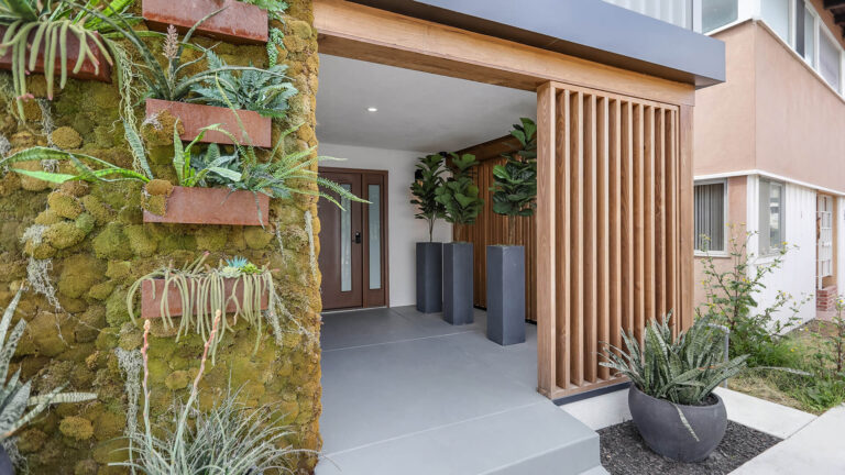 Moss wall and slatted wood entryway.