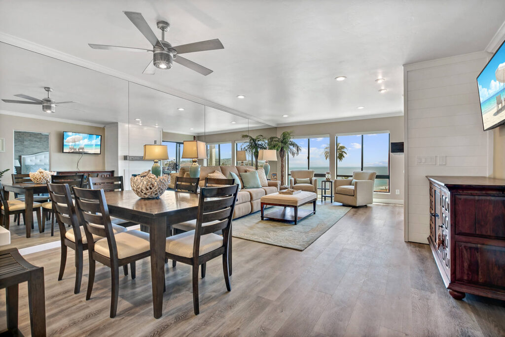 Living room with dining table and ocean view.