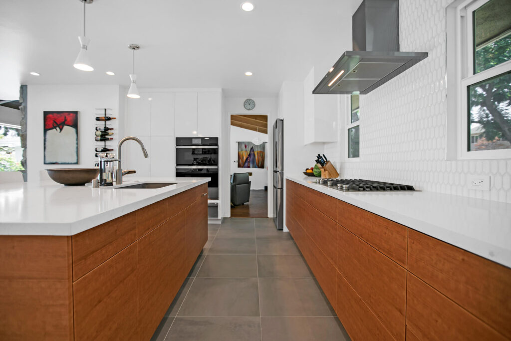 Large kitchen with white cabinets and wood grain island.
