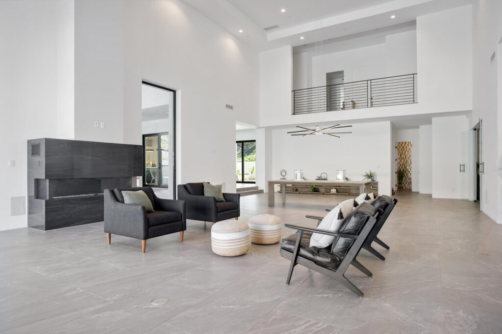 A living room with high ceilings and a fireplace.