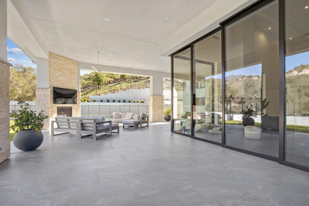 Modern patio with large glass doors.