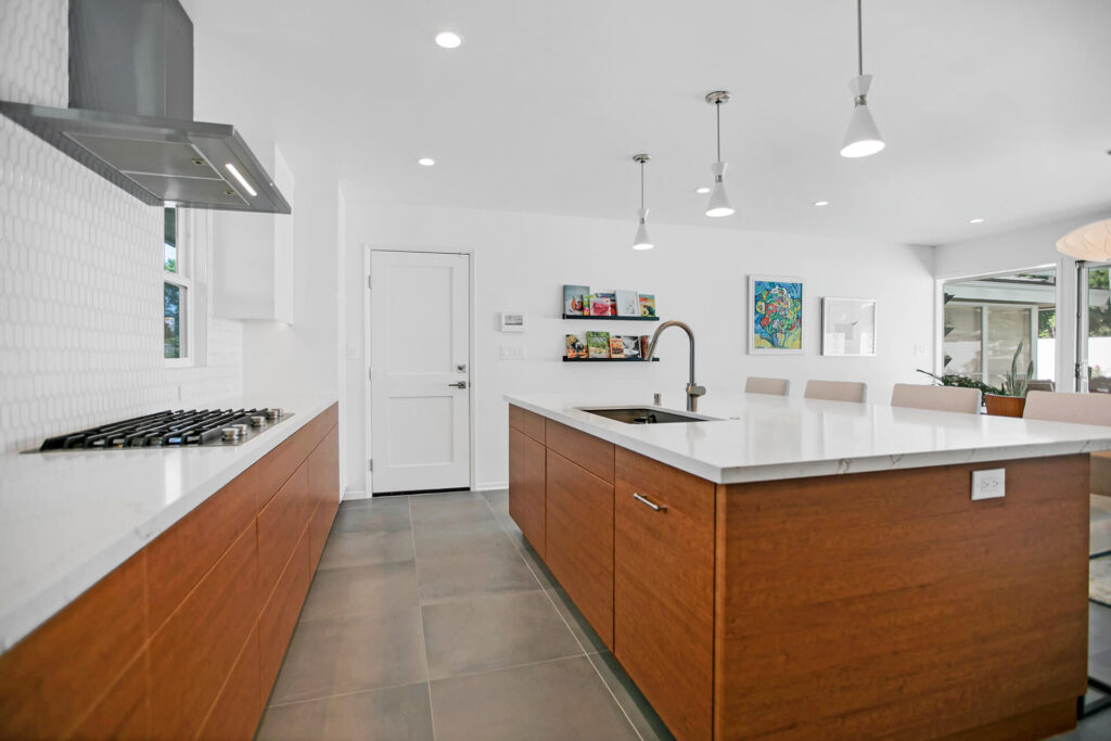 Modern kitchen with wood cabinets and white countertops