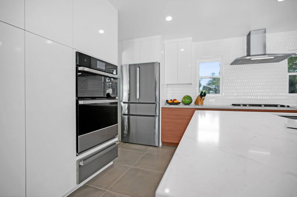 Modern kitchen with white cabinets and stainless steel appliances