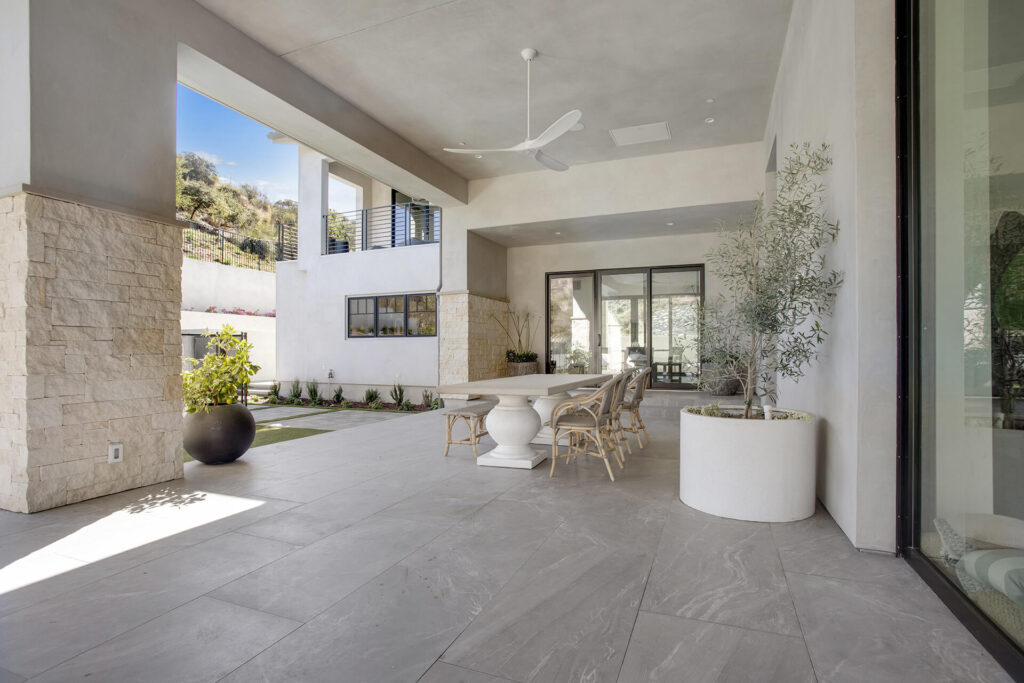 Outdoor patio with dining table and chairs.