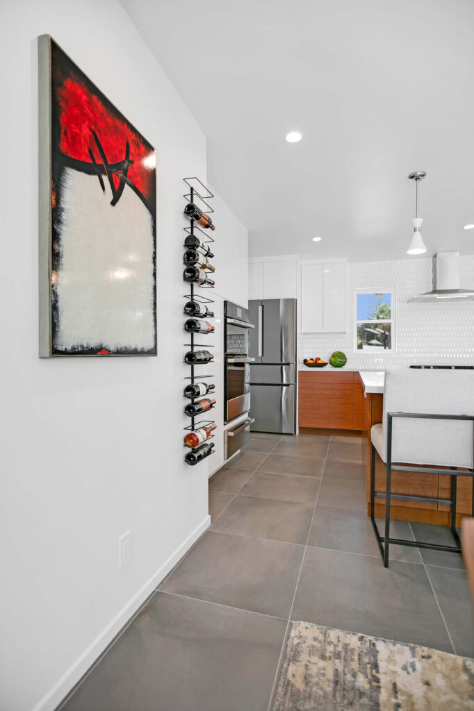 Modern kitchen with wine rack and large painting