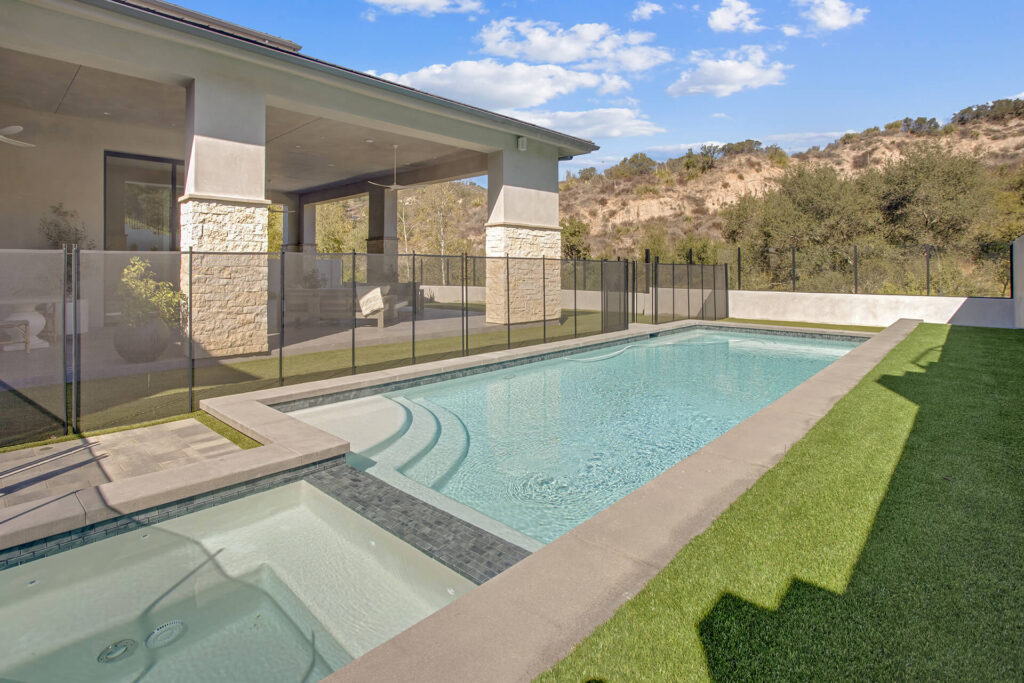 A modern house with a pool and spa.