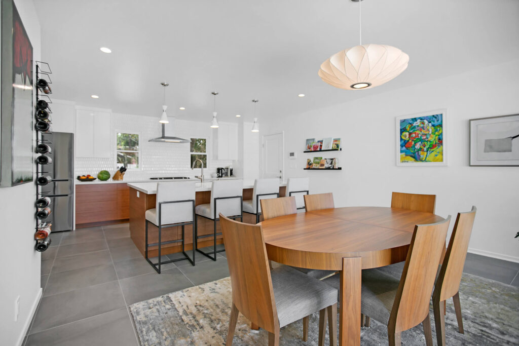 Large kitchen with wood table and chairs.