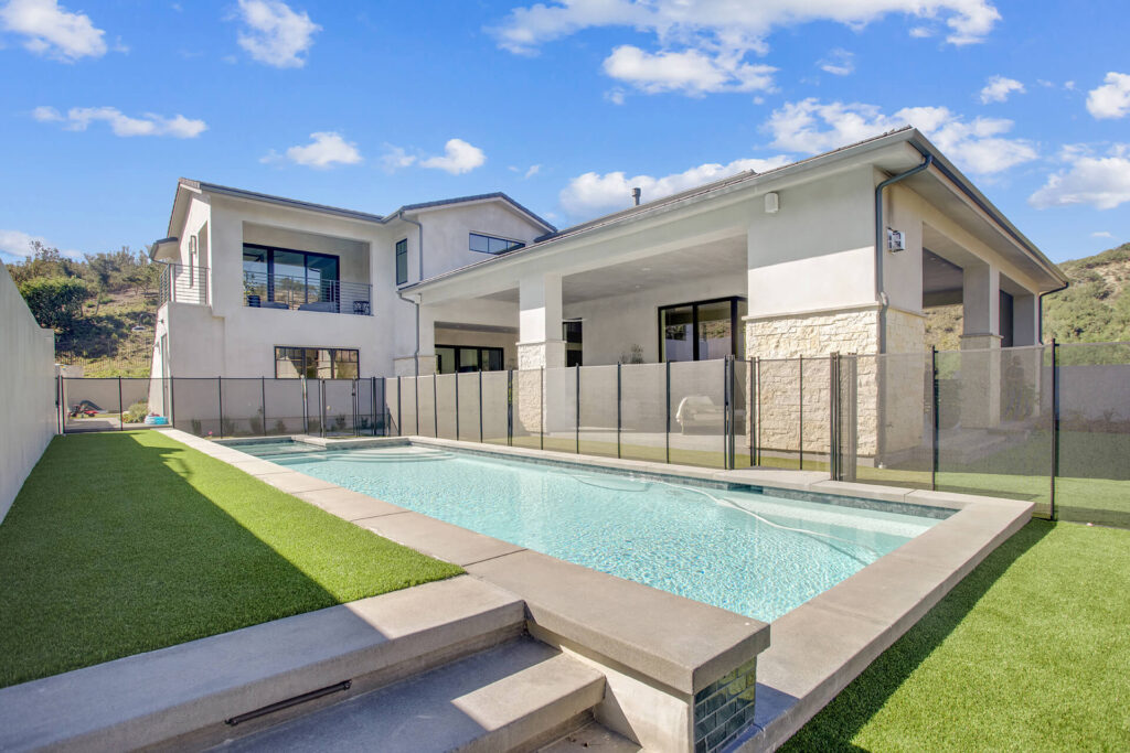 Modern house with pool and artificial grass.