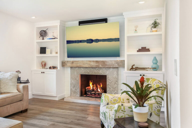 A living room with a fireplace, TV, and bookshelves.