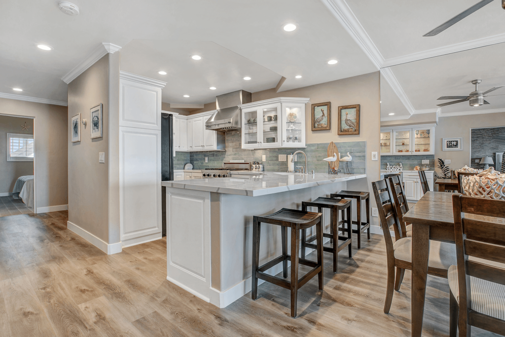A kitchen with a breakfast bar and a dining table.