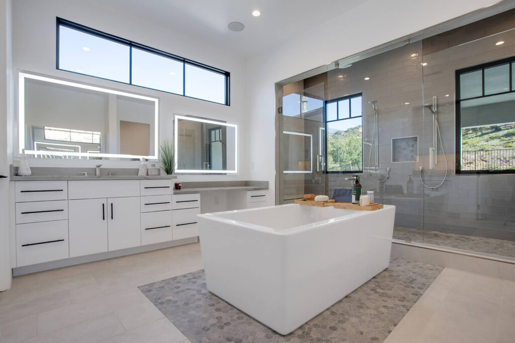 Modern bathroom with large bathtub and glass shower.