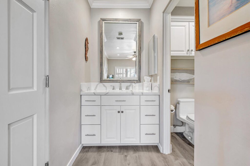 White vanity and toilet in bathroom.