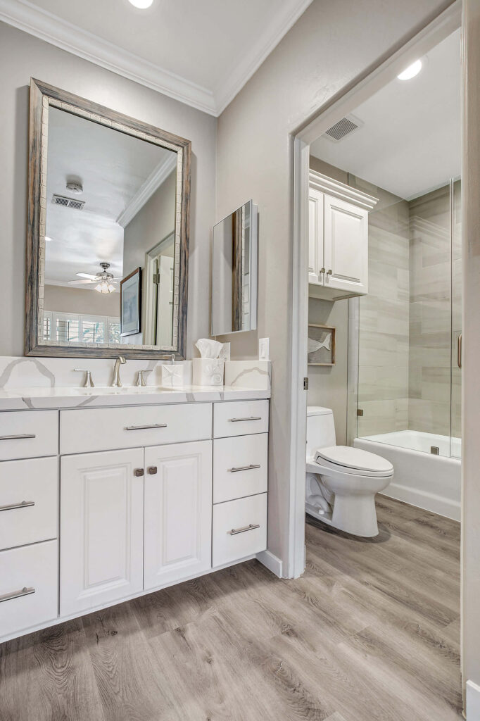 Bathroom with toilet, sink, bathtub and mirror.
