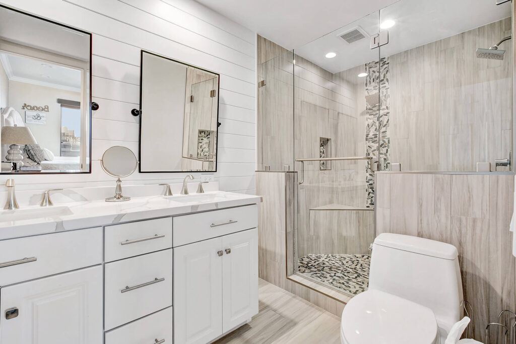 Modern bathroom with double vanity and large shower.
