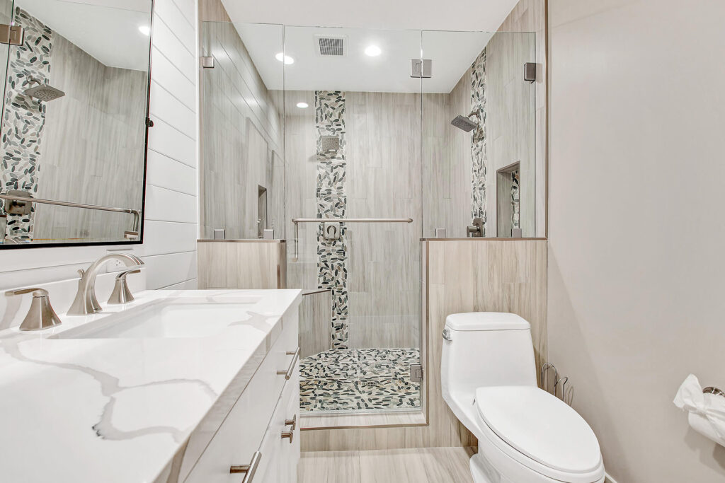 Modern bathroom with large glass shower enclosure.