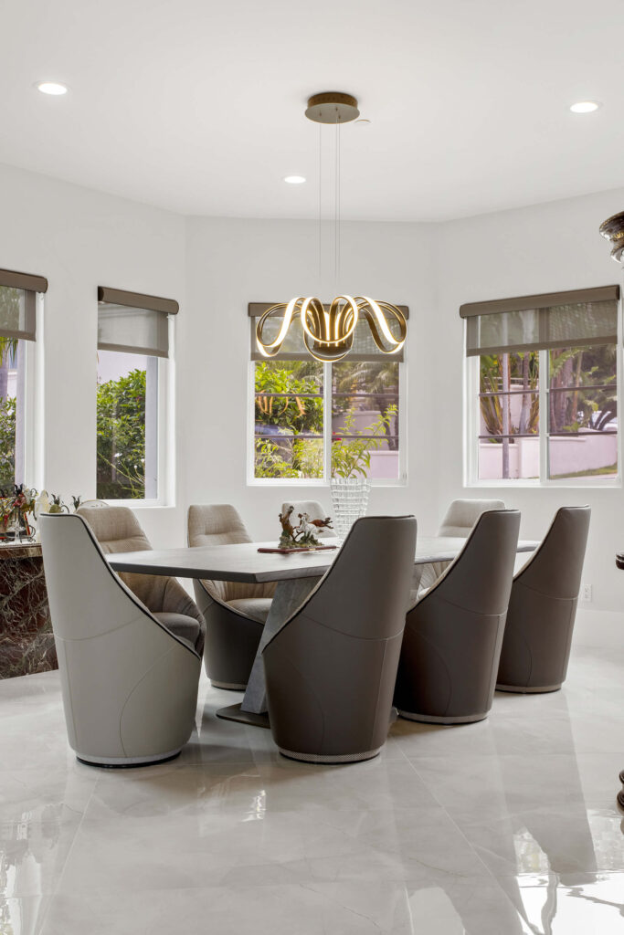 Elegant dining room with modern light fixture.