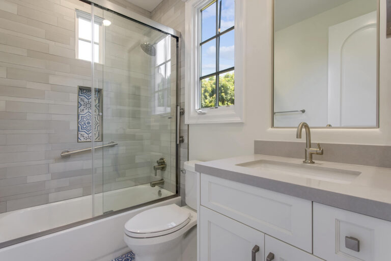 Modern bathroom with grey and white tiles.