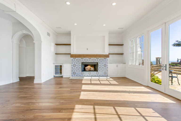 Bright living room with fireplace and French doors.